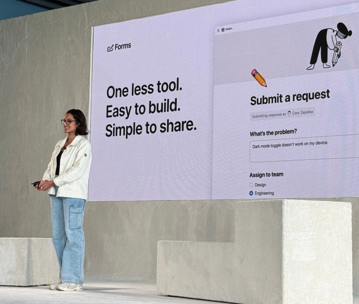 Saatchi Bhalla on stage at Make With Notion, in front of a slide reading “One less tool. Easy to build. Simple to share.” beside a Notion form